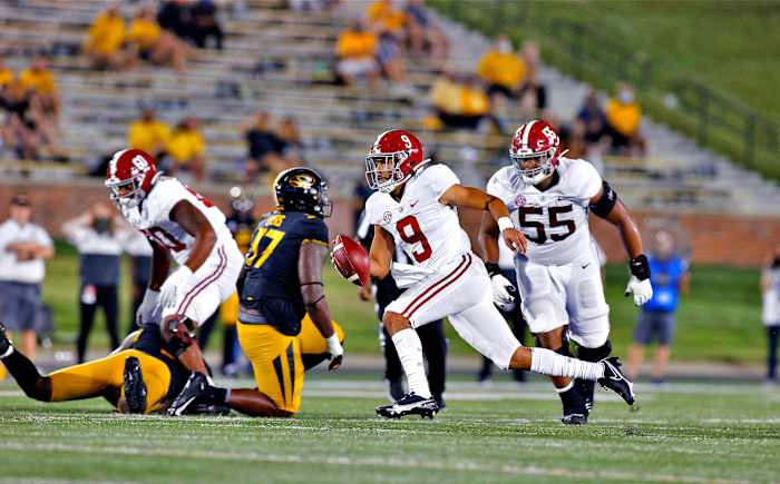 Alabama's Bryce Young runs with the ball